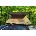 Forest green deluxe soft-top rooftop tent for 2-3 people mounted on a car in a wooded setting.