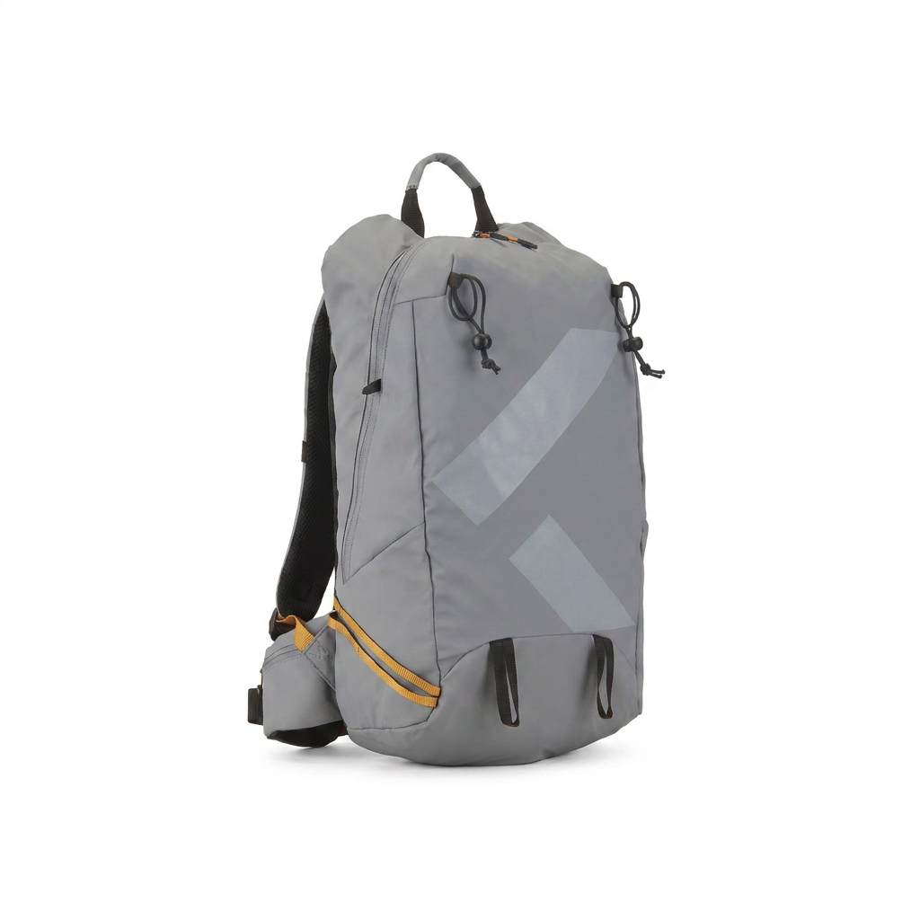 A studio product photograph of the Bugatti K&B Sport Rogers Touring Backpack in grey, angled to show its right side with orange zipper details. It is centered on a seamless white background with a soft shadow.