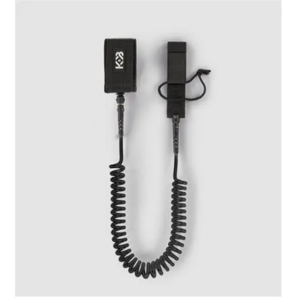 Black 7mm TPU coiled SUP ankle leash (10ft) with padded cuff and rail saver against a gray background.