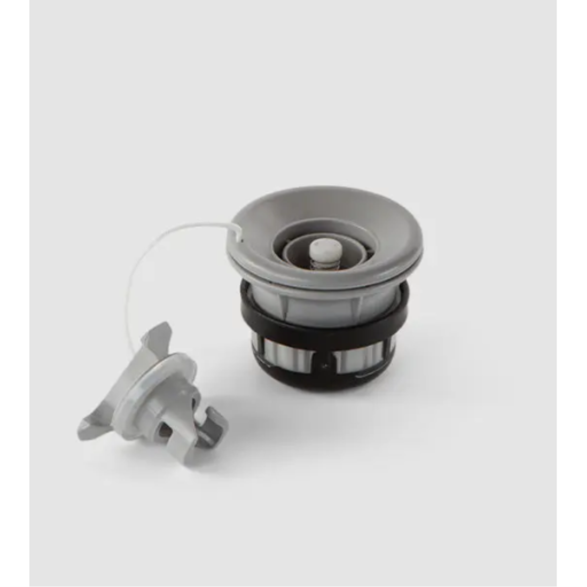 Grey and black PVC Hulkey-Roberts (HR) air valve for paddle boards with attached screw cap.
