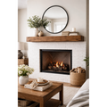 60-inch floating wood fireplace mantel in medium walnut over a white brick hearth with a round mirror.